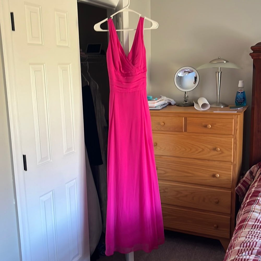 This dress is very flowy and elegant. It is hot pink and has a V neckline.